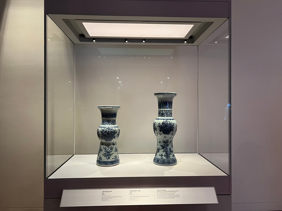 Ceramic vessels displayed inside an illuminated museum showcase